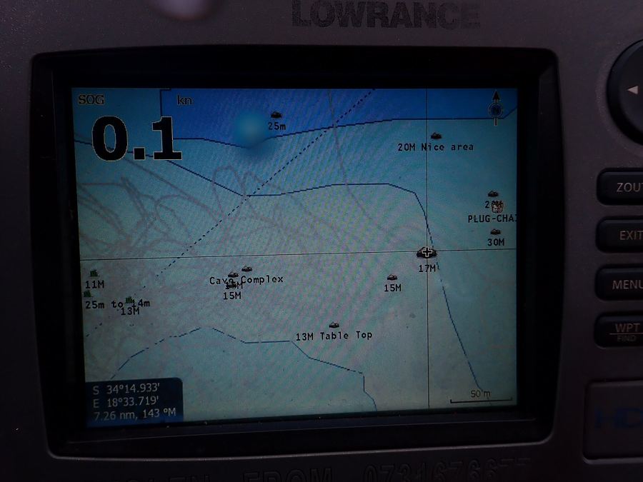 A Lowrance fishfinder/GPS unit showing a lake map with marked waypoints